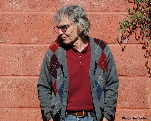 A second portrait photograph of the author from the waist up